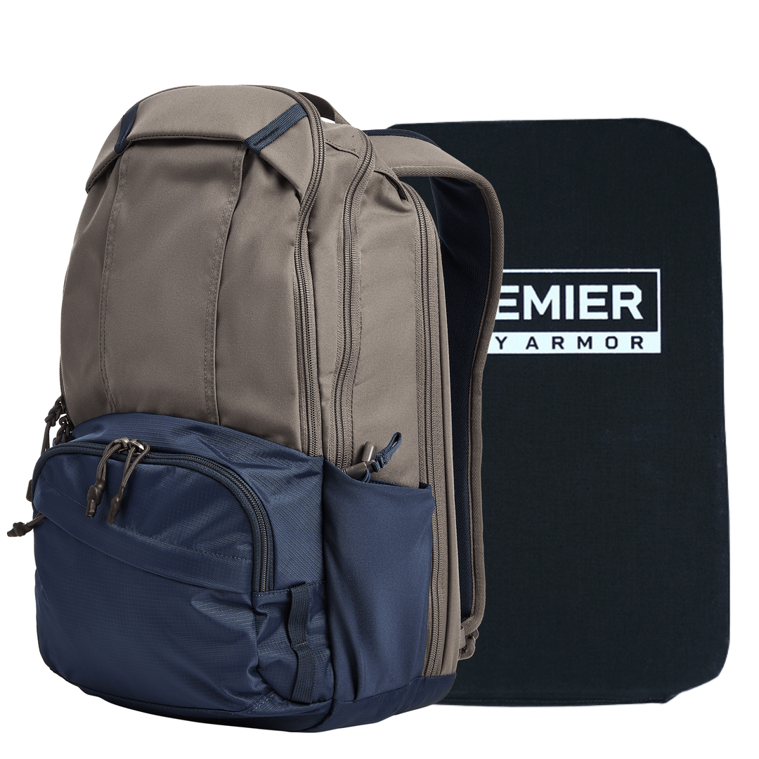 A tan and navy blue Armored Vertx Ready Pack X by Vertx/Premier is displayed beside a rectangular black shield panel labeled "PREMIER ARMOR." The backpack offers multiple zippered compartments and pockets for concealed carry.