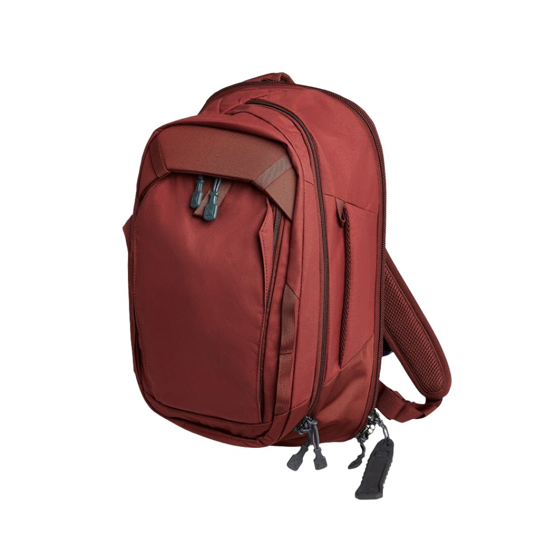 Side image of the Vertx transit sling 3.0 in Brick Red. Upgraded rapid access pull tabs and a compartment for your Premier Transit sling armor. 