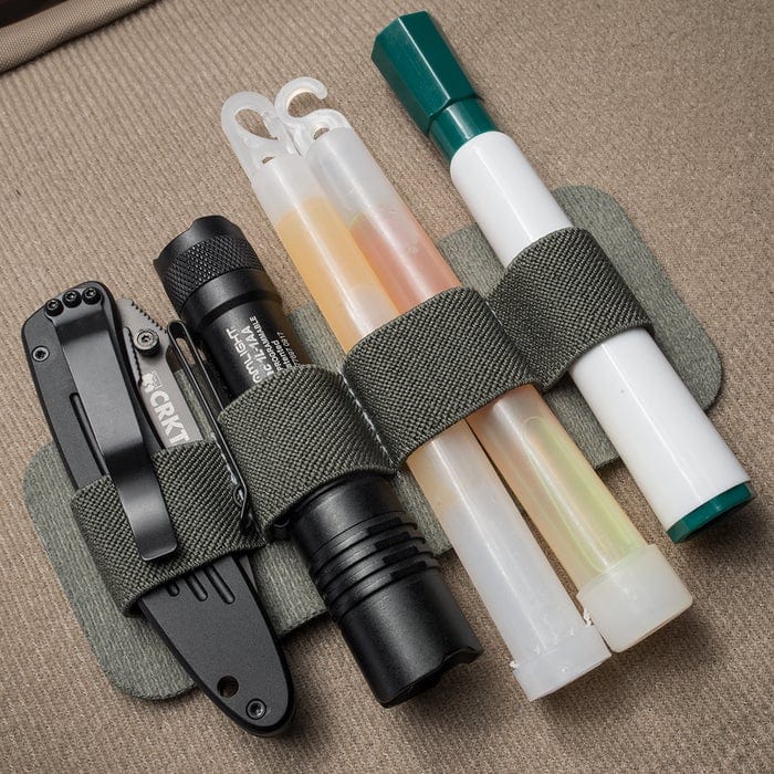 Image of MAK Band Standard holding EDC gear attached to a tactical bulletproof backpack. 