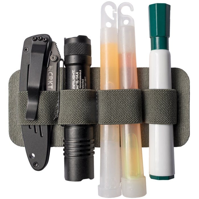 Image of MAK Band Standard holding EDC gear - flashlights, pocketknives, glo sticks, and markers. 